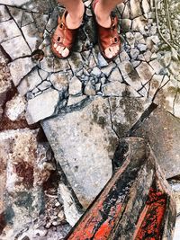 Low section of woman standing on rock