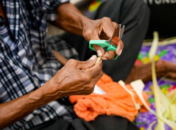 High angle view of senior man making art product