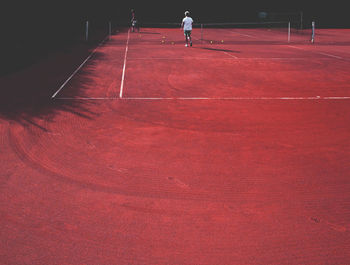 People at tennis at clay court