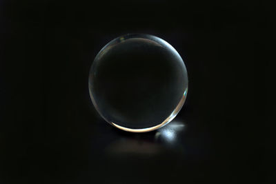 High angle view of crystal ball against black background