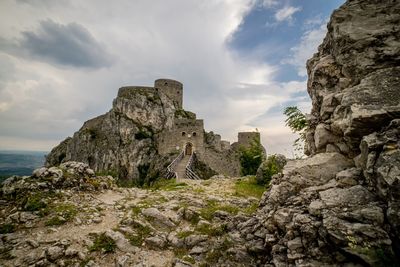 Rock formation amidst buildings against sky