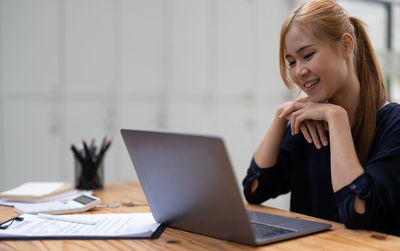 Businesswoman using laptop at office