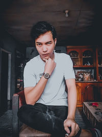 Portrait of young man sitting in restaurant