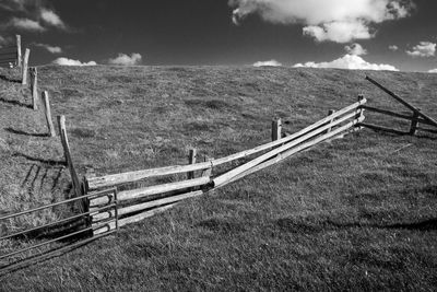 Fence on field against sky