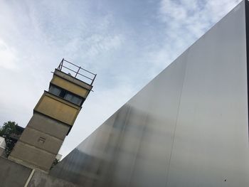 Low angle view of building against cloudy sky