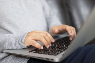 Midsection of woman using laptop