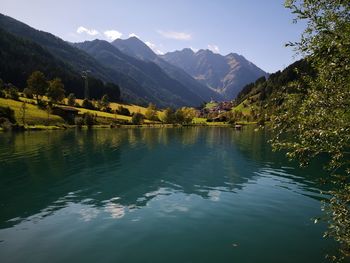 Scenic view of lake and mountains against sky