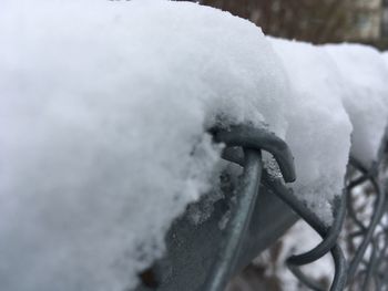 Close-up of snow on metal railing