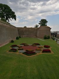 Stone structure in park against cloudy sky