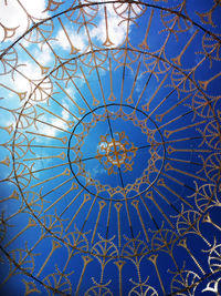 Low angle view of ceiling against cloudy sky