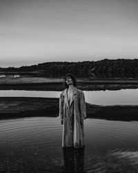 Portrait of a woman standing under the sky in the lake