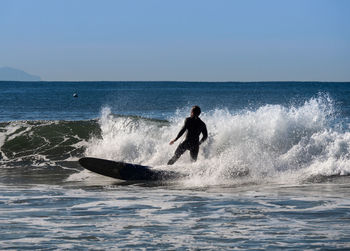 Man surfing in big wave near the coast