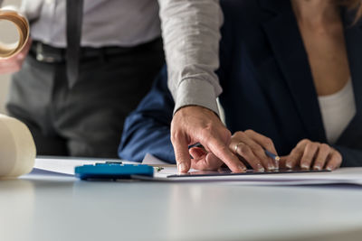 Midsection of man working at table