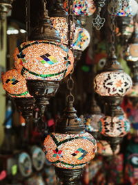 Close-up of decorations hanging for sale in market