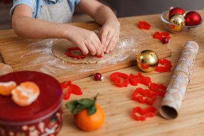 Midsection of boy preparing food on cutting board