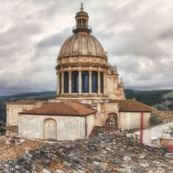 Buildings against cloudy sky