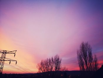 Low angle view of silhouette bare trees against sky during sunset