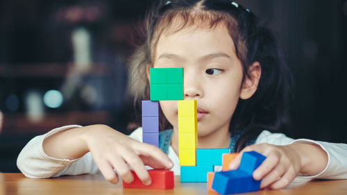 Portrait of boy with toy on table