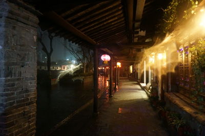 Illuminated underground walkway at night