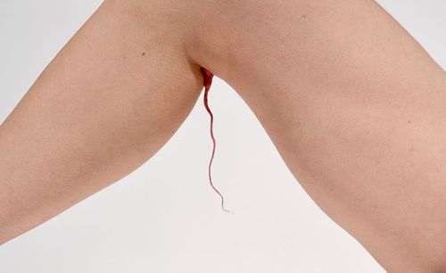 Close-up of woman hand over white background