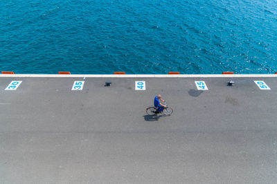 High angle view of people on road by sea