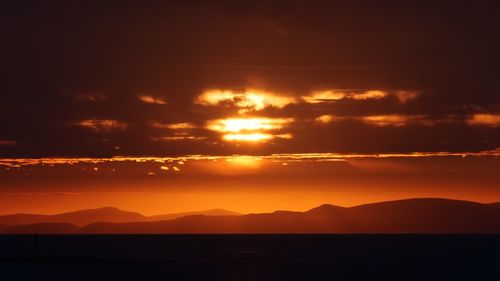 Scenic view of sea against romantic sky at sunset