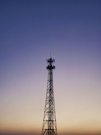 Low angle view of communications tower against sky during sunset