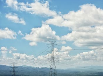 Low angle view of electricity pylon against sky