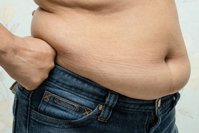 Midsection of shirtless man