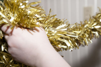 Close-up of hand holding tinsel