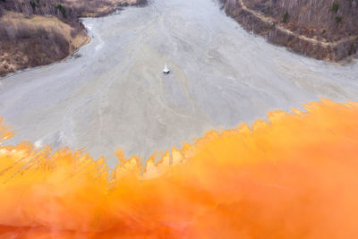 Aerial view of a toxic waste lake, with yellow chemical residuals flooded a church. geamana, romania