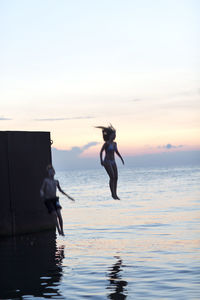 Youth jumping into sea, oland, sweden
