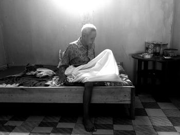 Woman sitting on seat at home