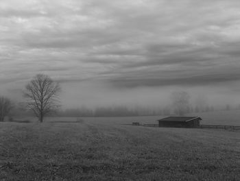 Scenic view of field against cloudy sky