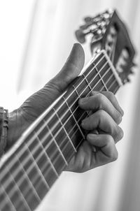 Cropped hand of woman playing guitar