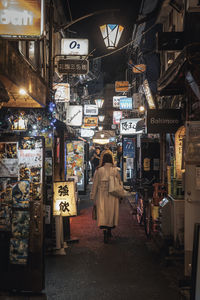 Rear view of people walking on street
