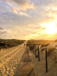 Scenic view of road against sunset close to the ocean.