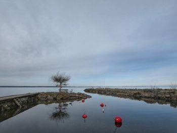 View of buoy in river against sky