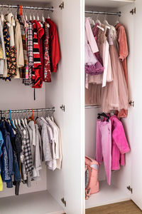 Clothes hanging on rack in closet