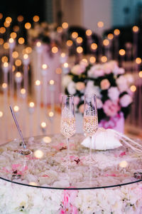 Illuminated candles on glass table