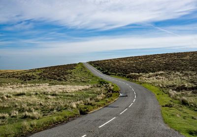 Empty road along countryside landscape