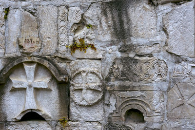 Low angle view of old sculpture on building wall