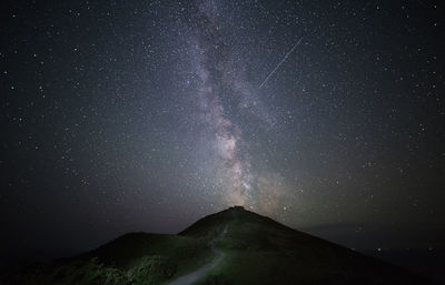 Scenic view of mountains against sky at night