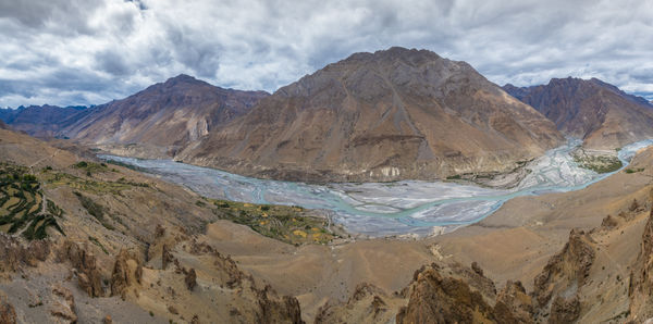 Scenic view of mountains against cloudy sky