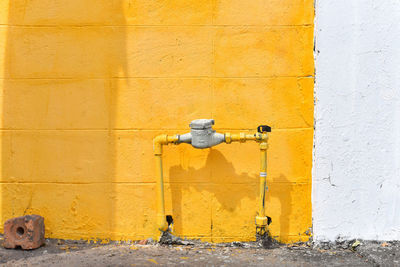 Close-up of faucet against wall