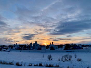 Scenic view of snow field against sky during sunset