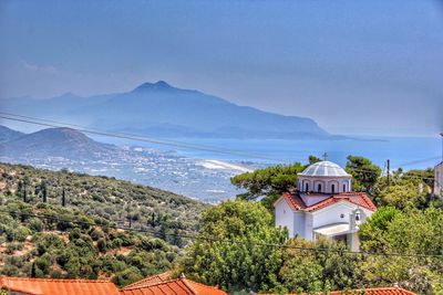 High angle view of houses and mountains against clear sky