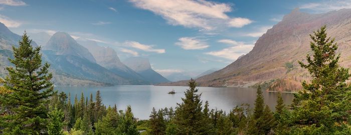 Scenic view of lake by mountains against sky