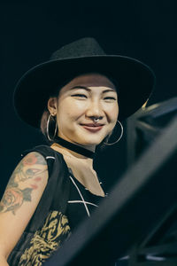 Portrait of smiling young woman at night