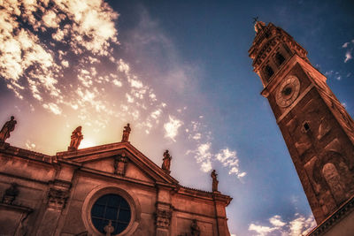 Low angle view of clock tower against cloudy sky